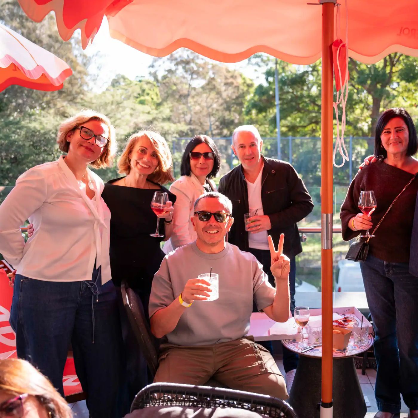 Friends celebrating under umbrellas at the club's Italian Republic Day event