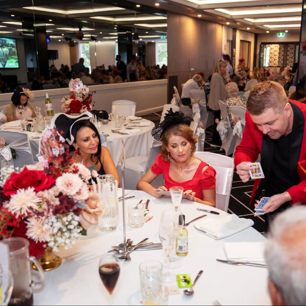 Guests in fascinators at a Melbourne Cup lunch in the club auditorium