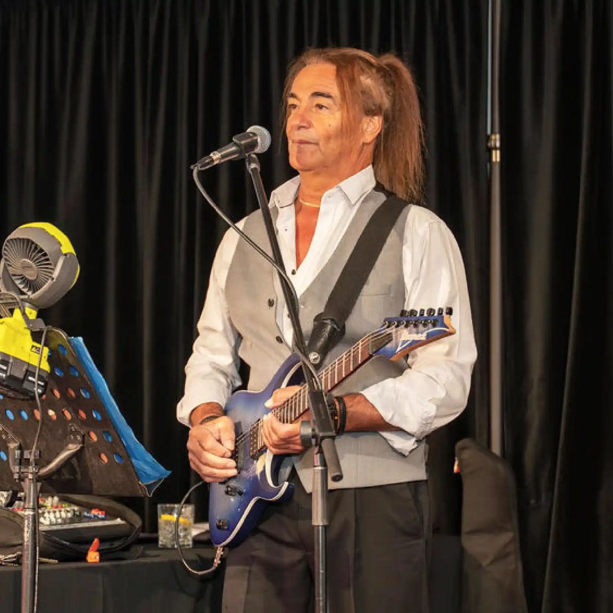 Tommy D performing with an electric guitar