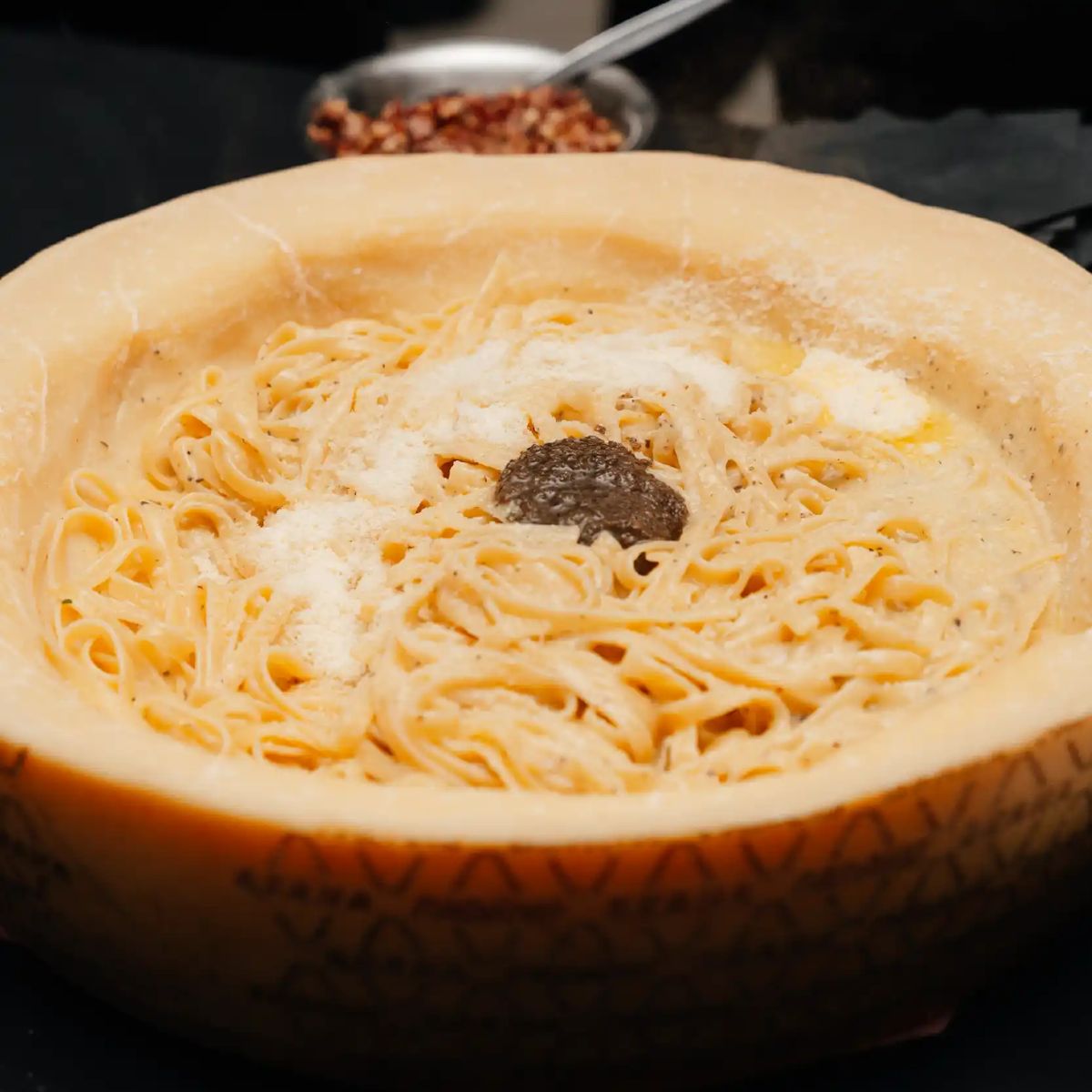 Pasta tossed in a parmesan wheel