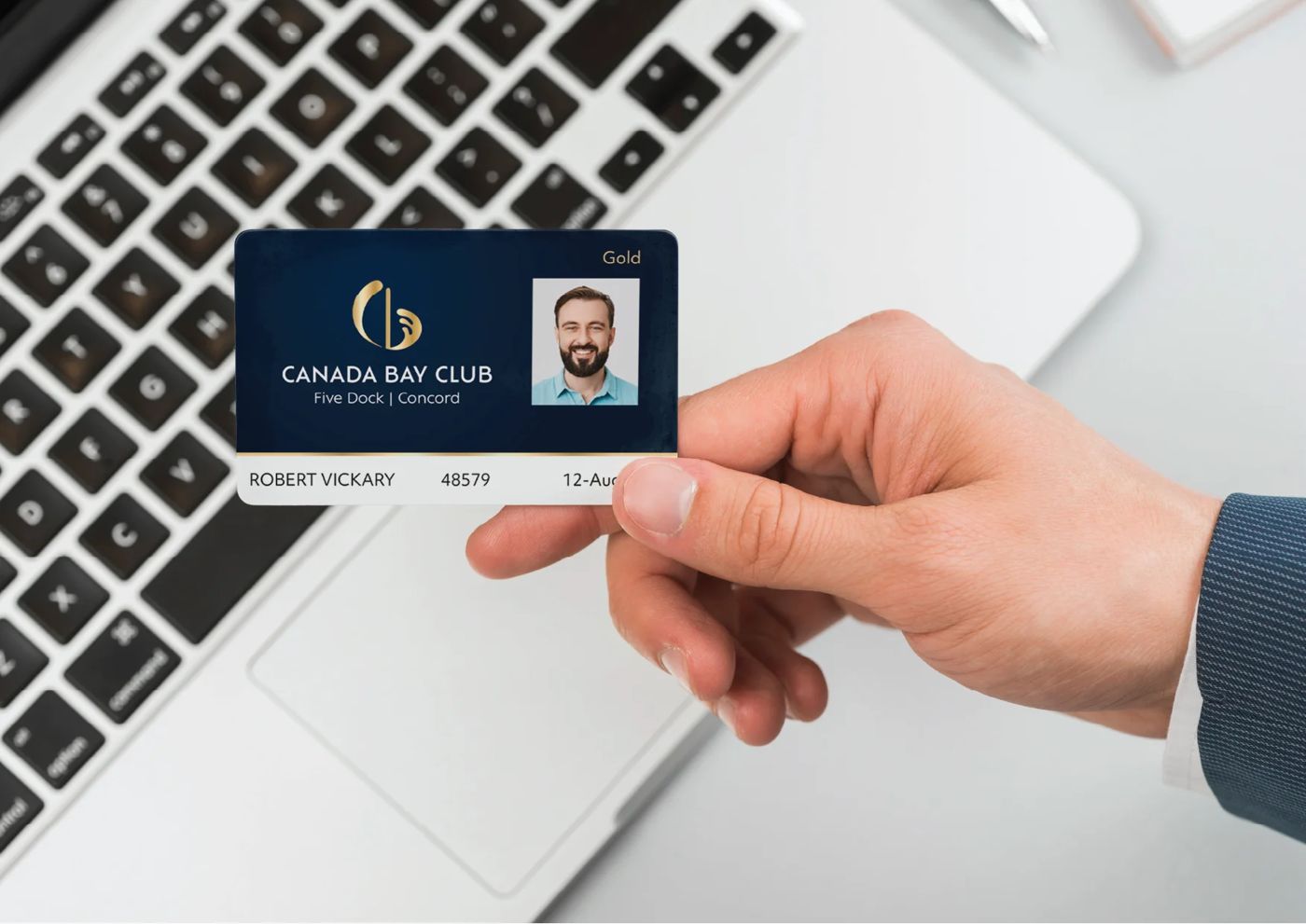 A hand holding a Canada Bay Club membership card